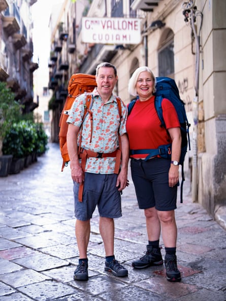 An older man and woman standing in a street