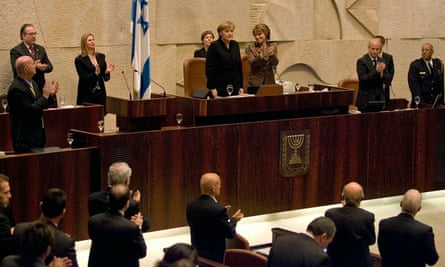 Chancellor Angela Merkel receives a standing ovation  