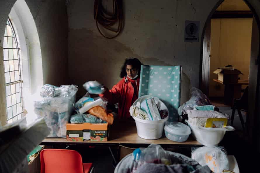 Beautine Wester sorts through bags pf donations in the church