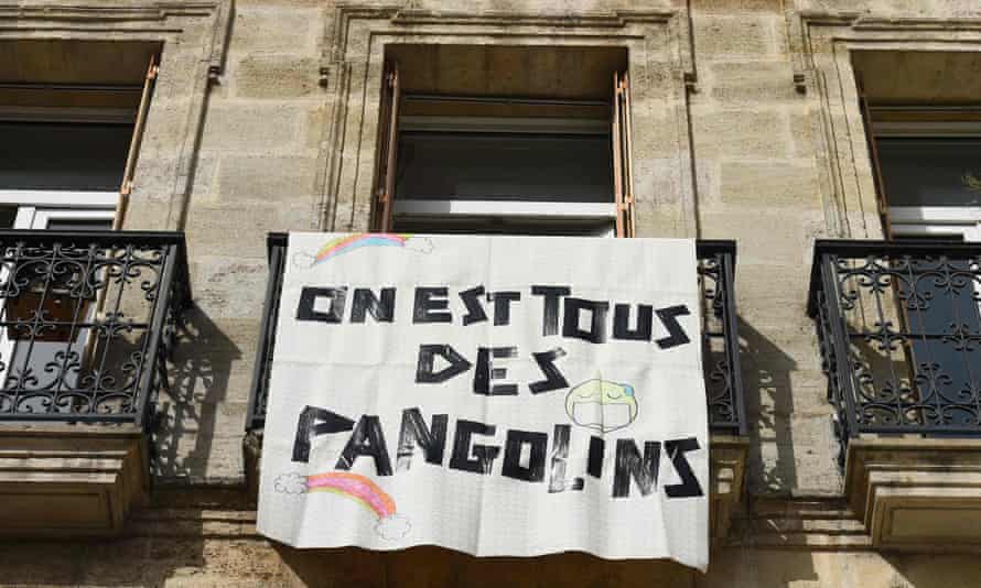 A banner reading “We are all pangolins” hangs on a blacony in Bordeaux, southwestern France, on March 19