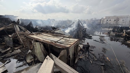 Smoke rises from destroyed building.