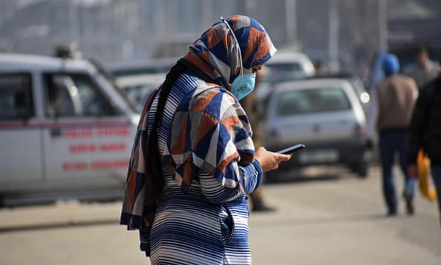 A woman uses her mobile phone in Srinagar in 2021 