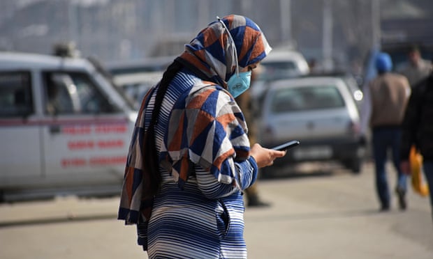 A woman uses her mobile phone in Srinagar in 2021