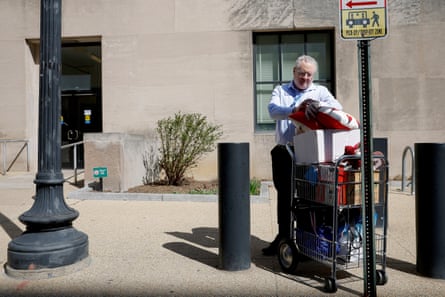 Man pushing cart pulls of items
