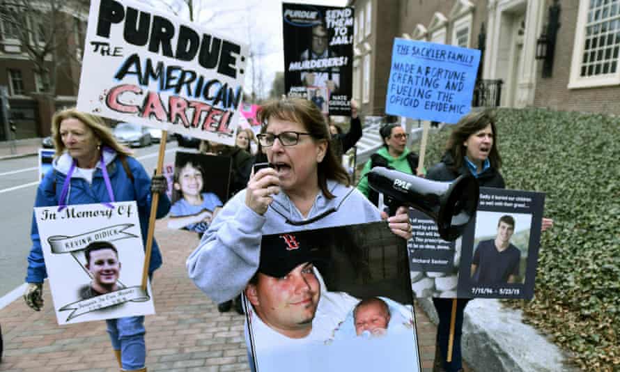 Cheryl Juaire, center, of Marlborough, Massachusetts, center, leads protesters near the Arthur M Sackler Museum at Harvard University, on 12 April.