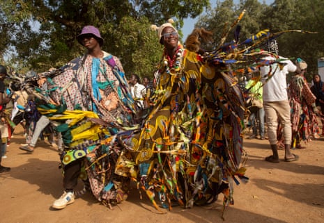 Two men in traditional robes twirling, sending tassels flying