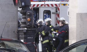Rescue workers carry a stretcher outside the Louvre museum.