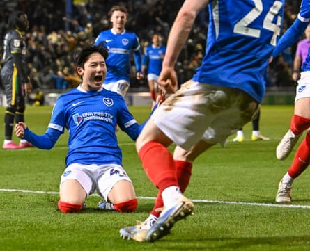 Yang Min-hyeok knee slides in celebration after scoring the winning goal during the Championship match between Portsmouth and Charlton at Fratton Park