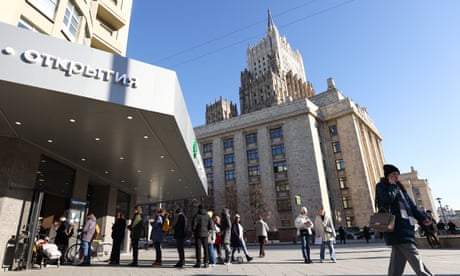 People queue by a cash machine in central Moscow on Wednesday.