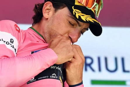 Giulio Ciccone celebrates on the podium wearing the maglia rosa