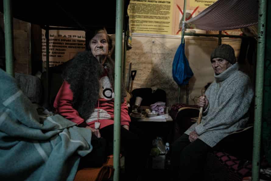 Vera, 83, and Inna, 69, sit on their bunk bed in the bunker of Ostchem factory in Severodonetsk, eastern Ukraine.