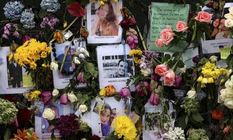 Photographs of victims hang on a memorial wall along a fence near the site at the Champlain Towers South Condo in Surfside, Fla., Wednesday, June 30, 2021. The apartment building partially collapsed on Thursday, June 24. (David Santigo/Miami Herald via AP)