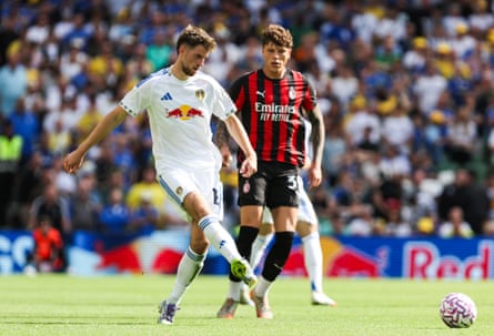 Leeds’ Anton Stach passes the ball under pressure from a Milan player