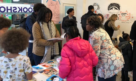 Customers in #ReadTheOnePerCent popup bookshop in Brixton Market that only sells books with non-white protagonists