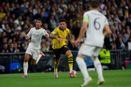 Borussia Dortmund’s Jadon Sancho runs with the ball away from former teammate Jude Bellingham, during the 2024 Champions League final against Real Madrid.