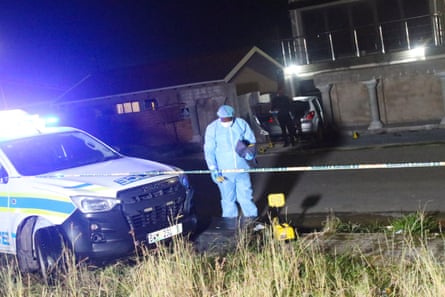 Forensic pathologist standing near vehicle at crime scene