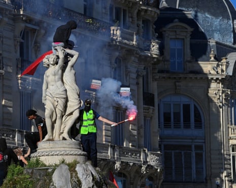 Protesters climb on the top of the Three Graces Fountain (Fontaine des Trois Graces) as they take part in a demonstration of high-school students in Montpellier, southern France.