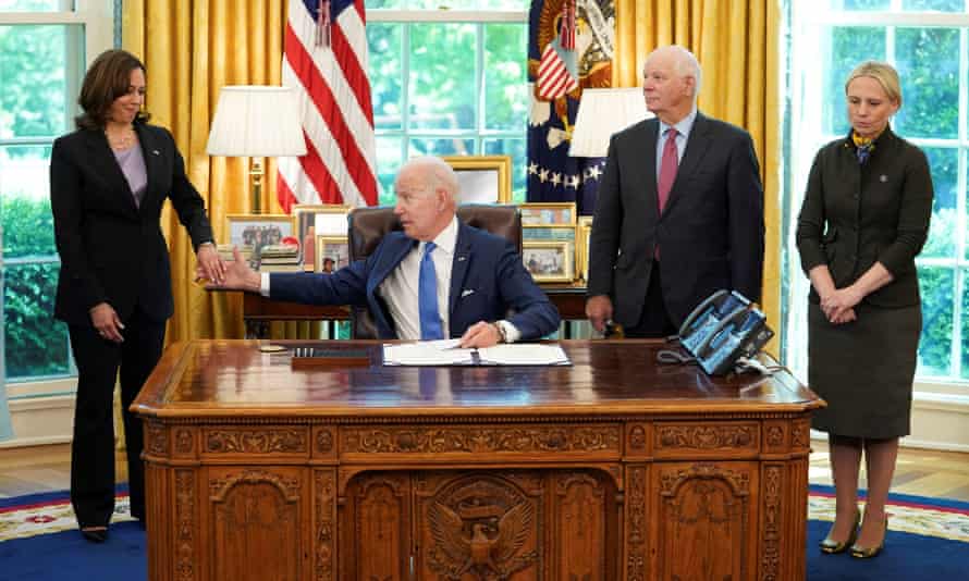 U.S. President Joe Biden clasps hands with Vice President Kamala Harris as Senator Ben Cardin (Democrat of Maryland) and Ukraine-born Representative Victoria Spartz (Republican of Indiana) wait for Biden to into law S. 3522, the “Ukraine Democracy Defense Lend-Lease Act of 2022” in the Oval Office on May 9.