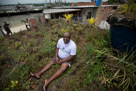 Luis Cassiano on his green roof at his home in Arara Park.