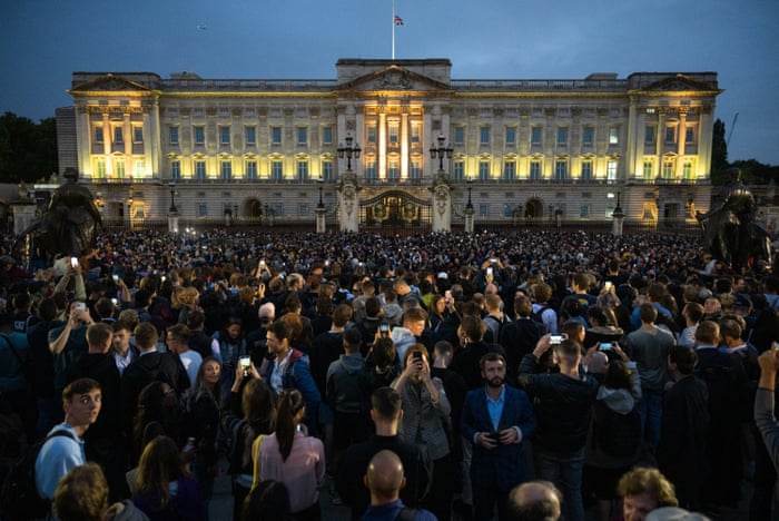 The union flag flies half mast as people gather at Buckingham Palace on Thursday night.