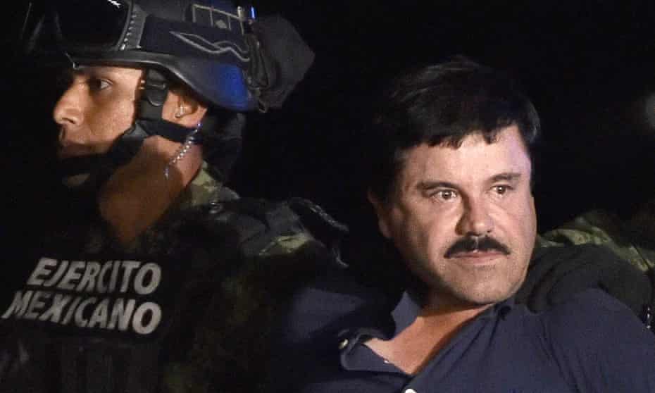 Drug kingpin Joaquin “El Chapo” Guzman is escorted into a helicopter at Mexico City’s airport following his recapture during an intense military operation in Los Mochis, in Sinaloa State. 