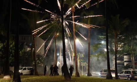 Fireworks explode during clashes with police in Le Port on Friday night.