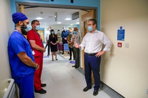 The Labour leader, Sir Keir Starmer, speaks with NHS staff during a visit to Royal Derby hospital in Derby, UK