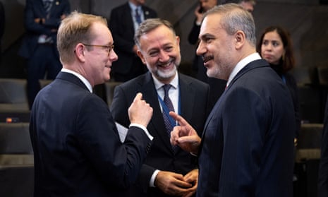 The Turkish foreign minister Hakan Fidan (right) speaks with his Swedish counterpart, Tobias Billström (left), before the Nato foreign ministers’ meeting in Brussels
