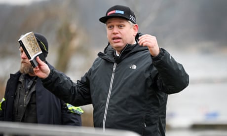 Rasmus Paludan holding a Qur’an while speaking