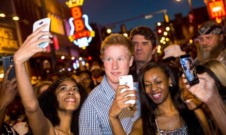 Hicks, looking superficially like Prince Harry, is mobbed by girls taking selfies with him