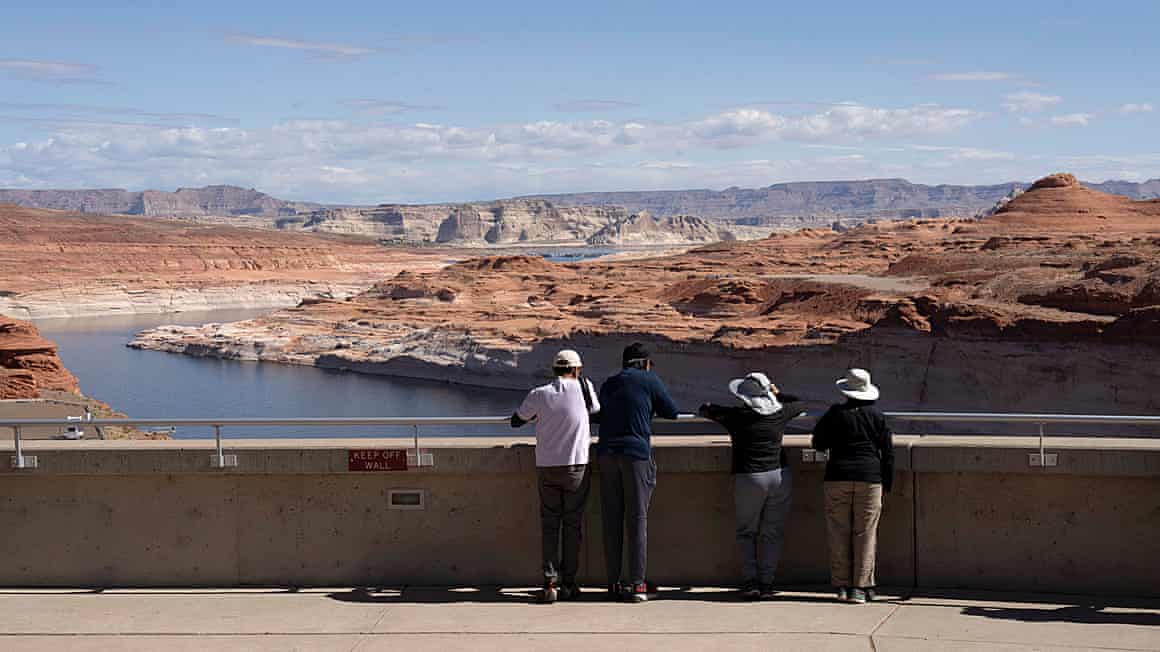 Tourists look at the Colorado River
