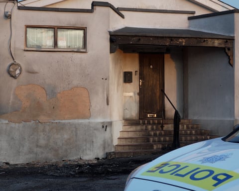A police car is parked outside of the fire-damaged mosque in Peacehaven