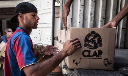 Men unload Clap boxes containing basic food supplies in Petare. Clap boxes are one of the measures implemented by Nicolás Maduro’s government to fight what they term as the “economic war”