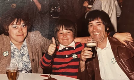 Stuart Cantrill, pictured as a boy, gives a thumbs up as he sits between mother Pamela and father Barrie