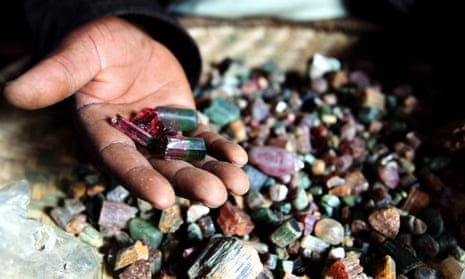 A Congolese mineral trader displays semi-precious tourmaline gem stones - used in laptops, mobile phones and jewellery, in eastern Congo July 24, 2010. 