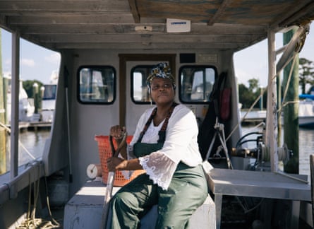 Mary Hill, who holds her family’s oyster leases, poses for a portrait on her boat in Newport News, Virginia. Oyster farming was shut down in February 2021 after a wastewater line break spilled sewage into the James River.