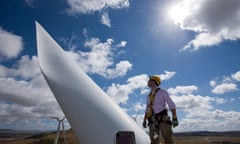 Sturt Daley, site manager, stands atop a wind turbine nacelle at Capital Wind Farm in Bungendore.