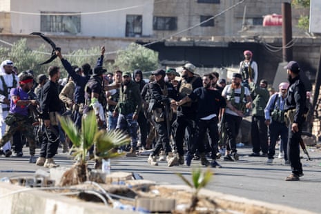 Internal security forces officers escort a Druze prisoner and prevent him from being attacked by Bedouins, at a security checkpoint in Walgha, Sweida province.