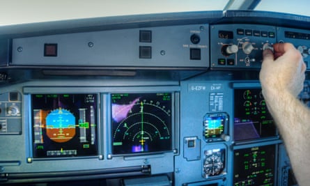 A pilot sets the autopilot on an Airbus A320 airliner