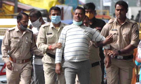 Vikas Dubey (centre) after he turned himself in to police in Ujjain, Madhya Pradesh, on Thursday.