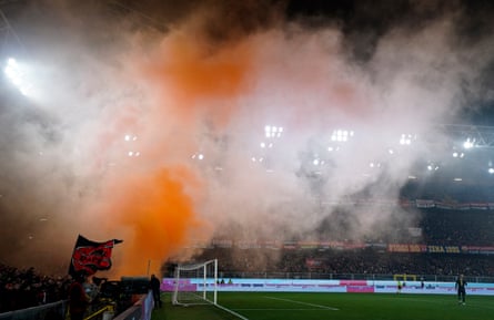 Smoke from flares drifts across the pitch at Genoa’s Luigi Ferraris stadium.