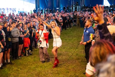 Phoebe Lunny (white dress) of Lambrini Girls goes into the crowd and asks queer people to step forward in order to celebrate them at Woodsies stage.