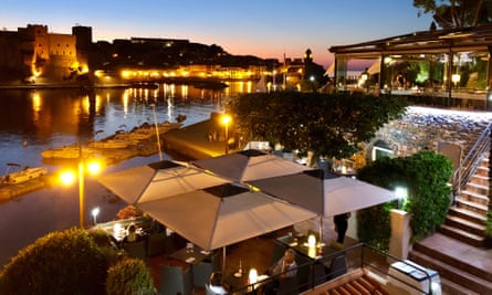 Le Neptune restaurant, Collioure, with sunset over harbour