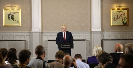 Boris Johnson greets his audience at the press conference