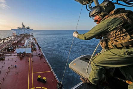 An armed forces member about to board the ship