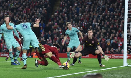 Mohamed Salah falls to the ground after a challenge by Arsenal defender Sokratis Papastathopoulos.