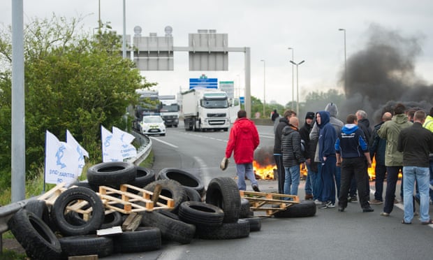 Striking ferry workers burn tyres as they block a road leading to the Channel tunnel.