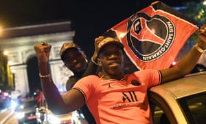 Paris Saint-Germain supporters wave flags as they celebrate on the Champs Élysées after their team’s 3-0 win over RB Leipzig.