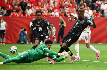 Cyle Larin beats Qatar goalkeeper Mahmoud Abunada to open the scoring in Vancouver.