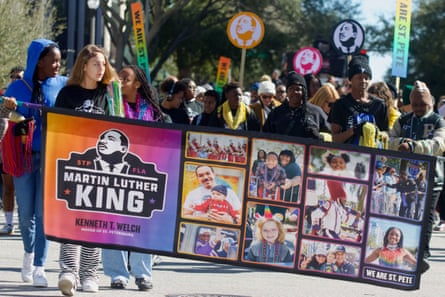 Young men and women carry a banner in support of Martin Luther King Day in downtown St Petersburg, Florida.